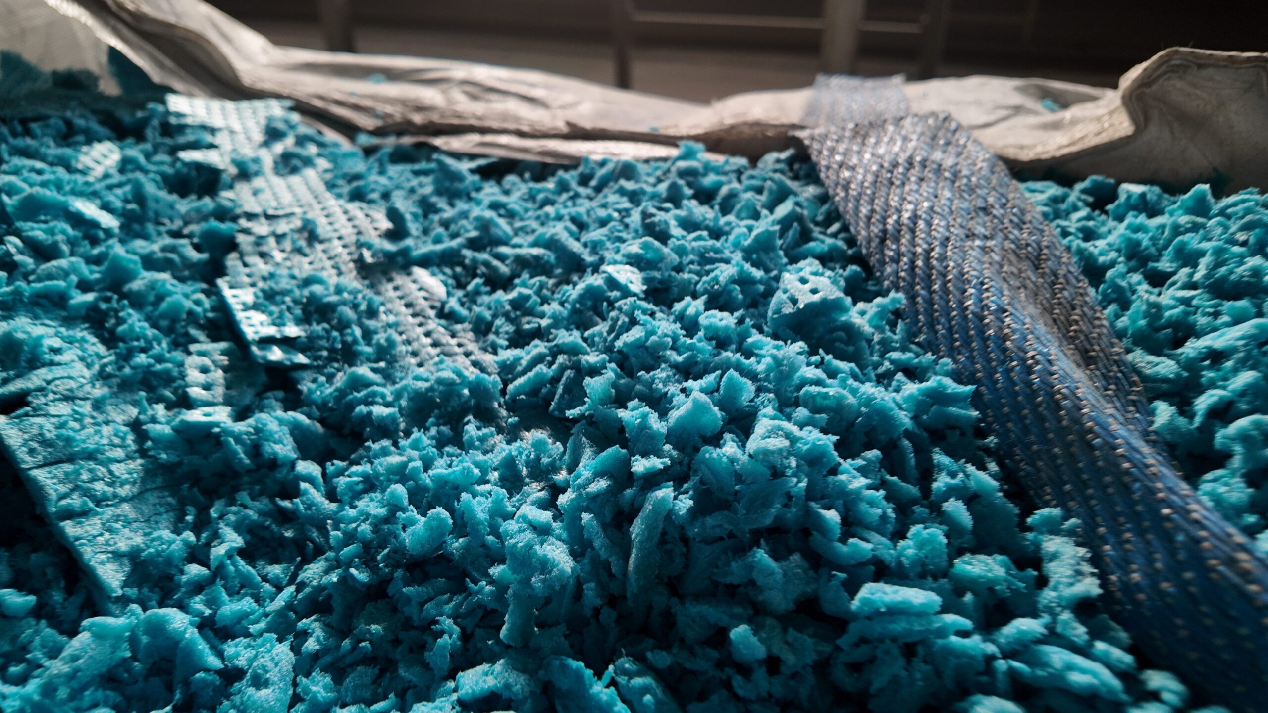Macro shot of high-quality blue XPS raw material granules - Showcasing the core foundation for closed-cell structure and Long-Term Thermal Resistance (LTTR)